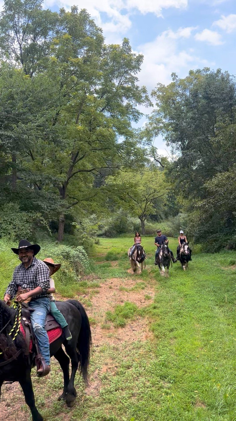 A group on a guided trail ride through the woods